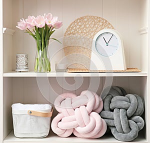 White shelving unit with flowers and decorative stuff