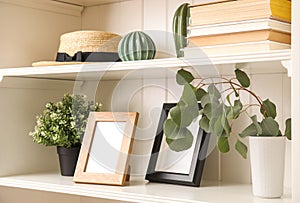 White shelving unit with plants and decorative stuff