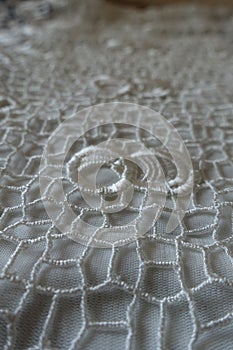 White shiny net like openwork lacy fabric