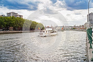 A white ship in the river Meuse near the bridge of the Arches