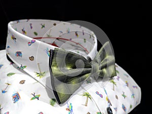 White shirt with bright summer patterns with a beautiful green bow tie