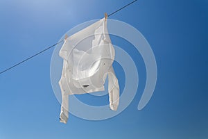 White shirt hanging to dry on clothes line