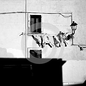 White shirts drying on a line in the Sardegnan city of Alghero, Italy