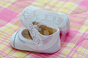 White shoes for baby girl with ornament on the sole photo