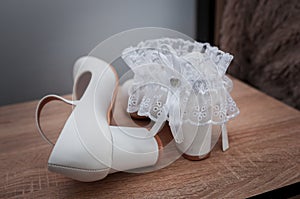 White shoes and bridal garter. Bride morning. Bride& x27;s accessories
