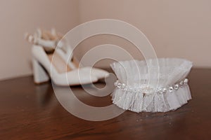 White shoes and bridal garter. Bride morning. Bride's accessories