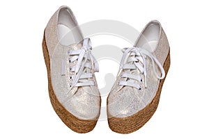 White shoes isolated. Closeup of a pair brown white elegant female leather high-heeled shoes isolated on a white background.