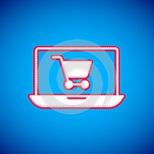 White Shopping cart on screen laptop icon isolated on blue background. Concept e-commerce, e-business, online business