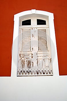White Shutters On Red Building
