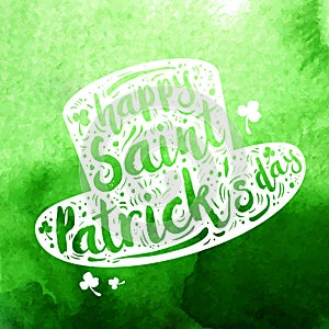 White silhouette Patrick hat on green watercolor background. Calligraphy Happy St. Patrick`s day, design element, icon