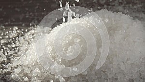 White silica gel crystals fall in a heap