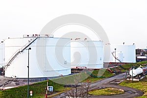 White silo tanks in a tank farm with blue sky