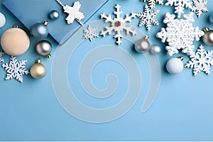 White, silver baubles and snowflakes on a blue, blue background. Top view.Christmas bright background, banner with space for your