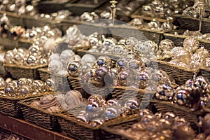 White and silver christmas tree ornaments and balls, advent market stall close up, photo