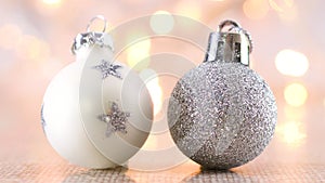 White and silver glitter Christmas ornaments on light theme with blinking lights