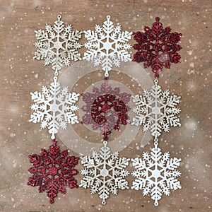 White, silver, red Snowflakes on wooden background