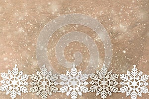 White, silver Snowflakes on the wooden background