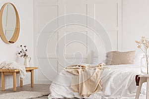 White simple bedroom design with mirror and bed with white sheets