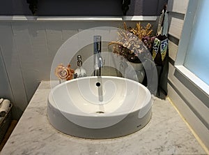 White Sink on marble and napkin basket in bathroom at restaurant, washstand bathroom in hotel