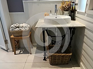 White Sink on marble and napkin basket in bathroom at restaurant, washstand bathroom in hotel