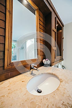 White sink and water facuet decoration in barhroom