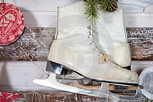 White skates on a wooden wall