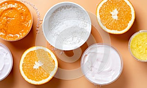 White skin cream, salt, scrub and oranges on a beige background, top view, banner.