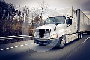 White sleeper 18 wheeler truck on highway