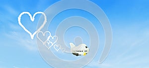 White small airplane toy flying in the sky and squirt white smoke is white hearts shape.