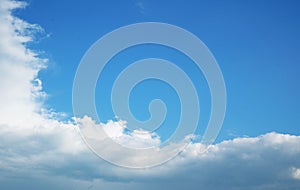 White small clouds on a blue sky on a sunny summer day.