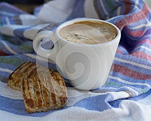 White small cup of espresso with cookies and spoon