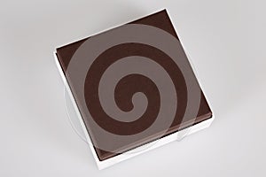 White small Gift Box with brown cower in grey background