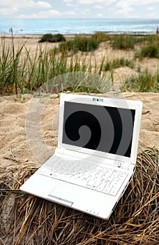 White small Laptop on the beach