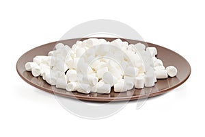 White small marshmallow on a brown dish