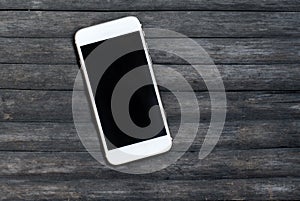 White smartphone on grey wooden background. Personal device mockup