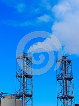 White smoke from the chimneys of the heating station.