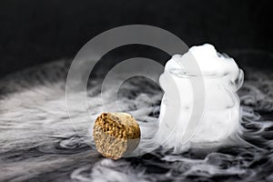 White smoke inside glass bottle at black background, Mistery hal