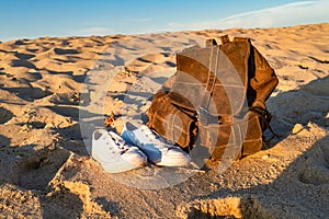 White sneakers and backpack on a sandy beach. Baltic Sea, Hel, Poland