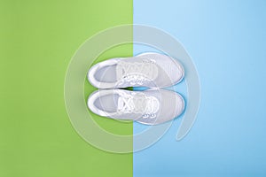 White sneakers on blue and green background.