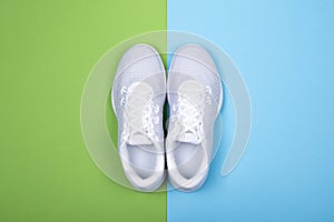 White sneakers on blue and green background.