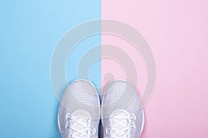 White sneakers on blue and pink background.