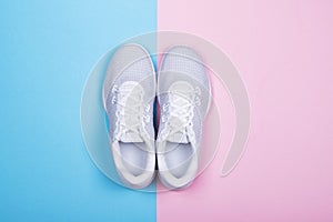 White sneakers on blue and pink background.