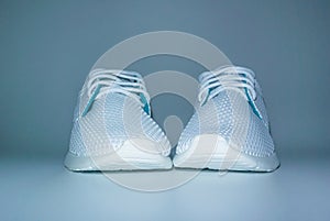 White sneakers for fitness and yoga on a light background close up