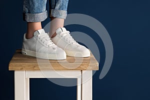 White sneakers on the legs of the girl