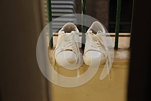 White sneakers shoes on the window