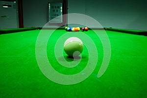 White snooker ball on snooker table. Billiard balls on table. White ball in the center.