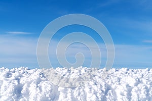 White snow with blue cleared sky background for display product or montage