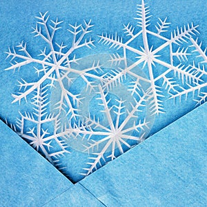 White snowflakes in the blue envelope