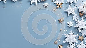 White snowflakes, golden stars on a blue background. Top view.Christmas bright background, banner with space for your own content