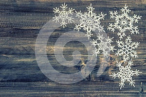 white snowflakes over rustic wooden background. christmas decoration